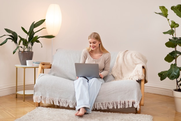 Free photo woman holding laptop full shot