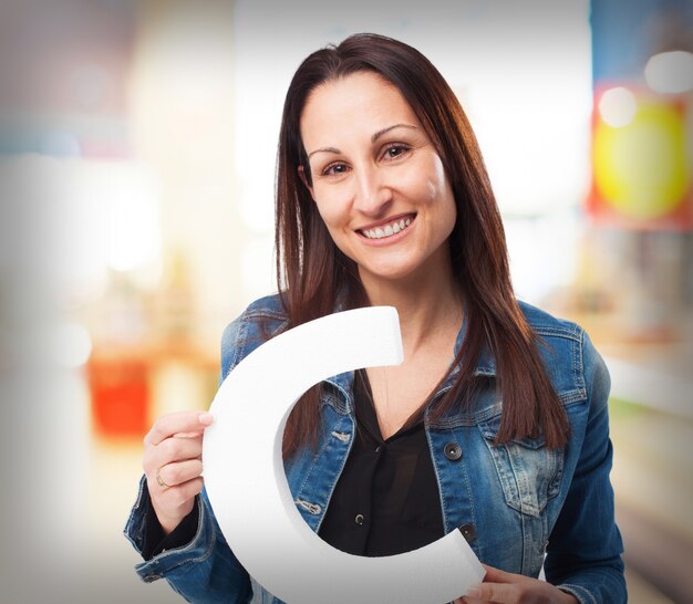 Woman holding the letter "c"