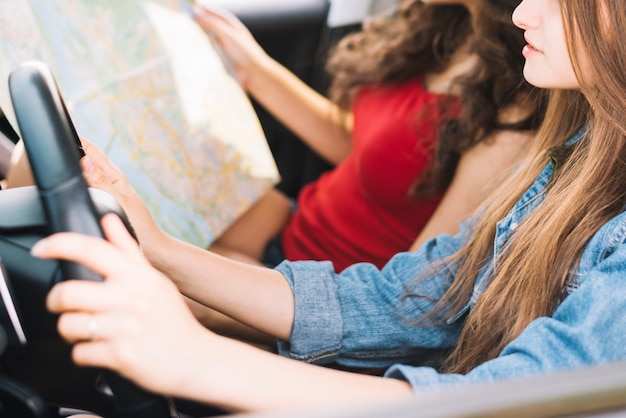 Free photo woman holding map in car