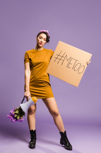 Free photo woman holding megaphone and cardboard front view