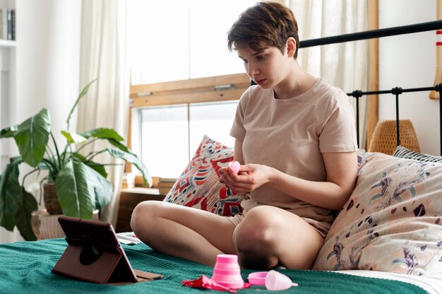 Woman holding menstrual cup full shot