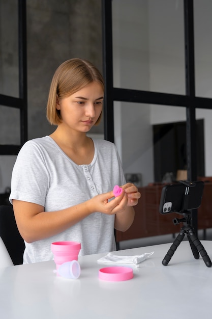 Free photo woman holding menstrual cup side view