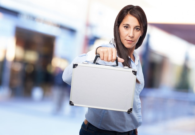 Free photo woman holding a metallic briefcase