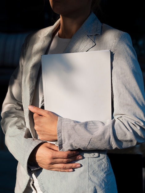 Woman holding a mock-up magazine