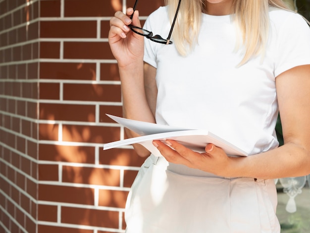 Free Photo woman holding a mock-up magazine