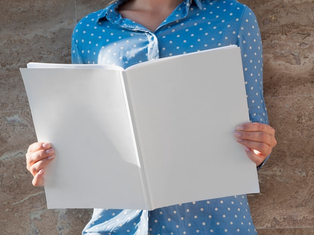 Free Photo woman holding a mock-up magazine