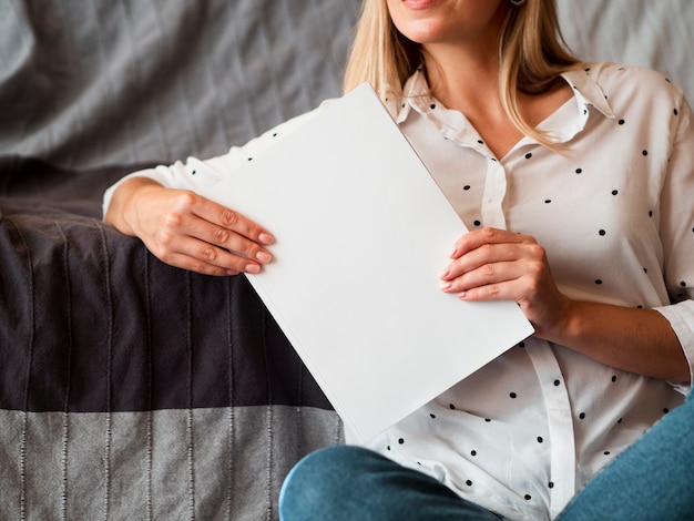 Woman holding a mock-up magazine