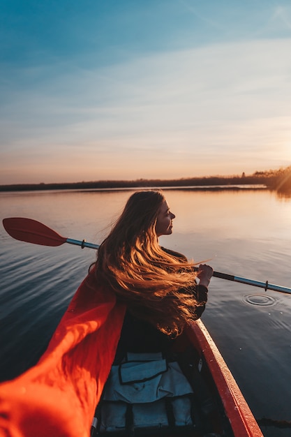 Free photo woman holding paddle in a kayak on the river