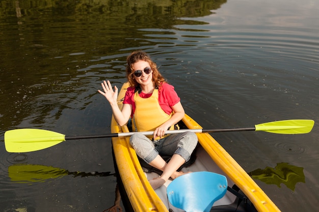 Free Photo woman holding paddle in kyak