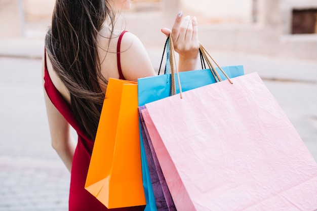 Free photo woman holding paper bags in one hand