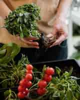 Free photo woman holding plant pot with exterior roots