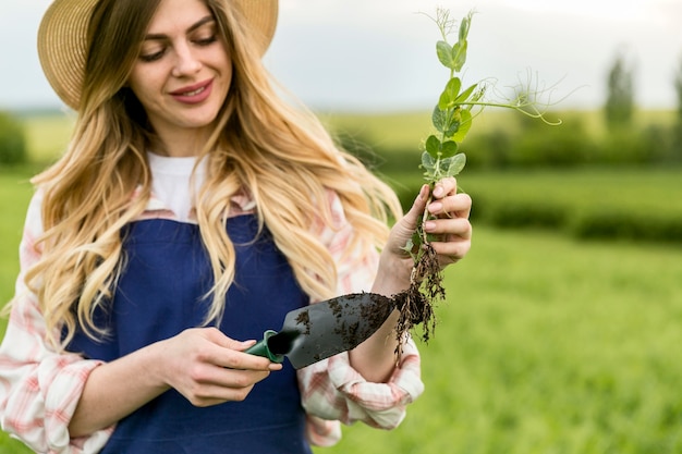 Free photo woman holding plant