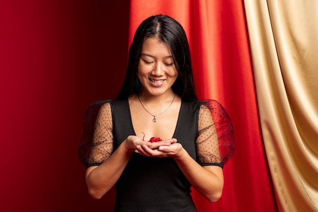 Free photo woman holding rat figurine for chinese new year