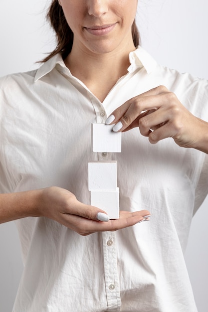 Woman holding small cubes in hand