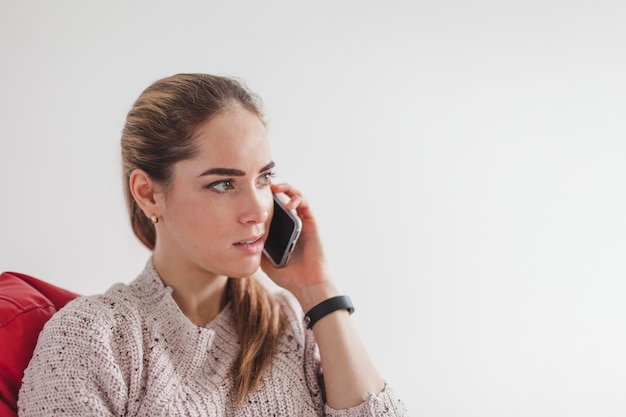 Free Photo woman holding smartphone at ear