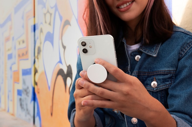 Woman holding smartphone front view