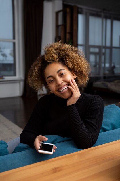 Woman holding smartphone medium shot