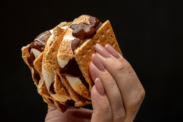 Free photo woman holding some tasty s'mores