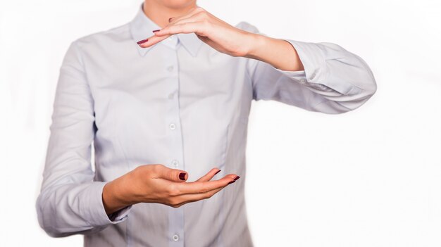 Woman holding something in hands on white background