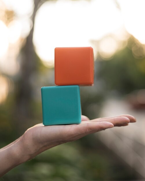 Woman holding stacked colored cubes