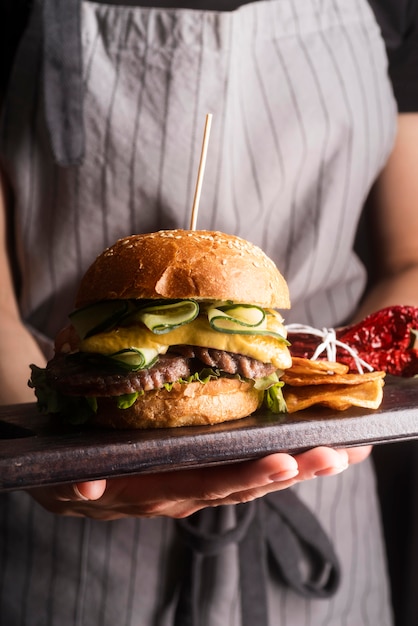 Woman holding a tasty meal with hamburger