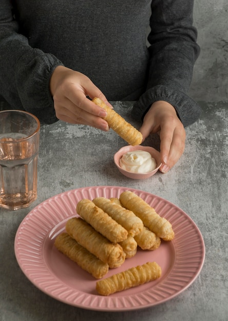 Woman holding traditional tequenos dish