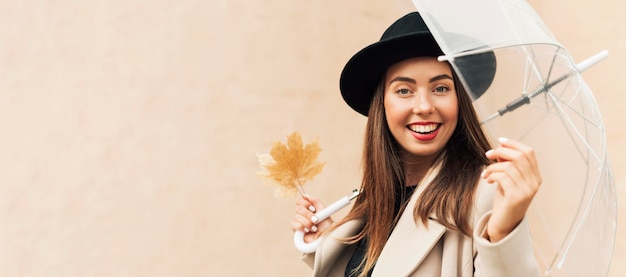 Free photo woman holding a transparent umbrella with copy space