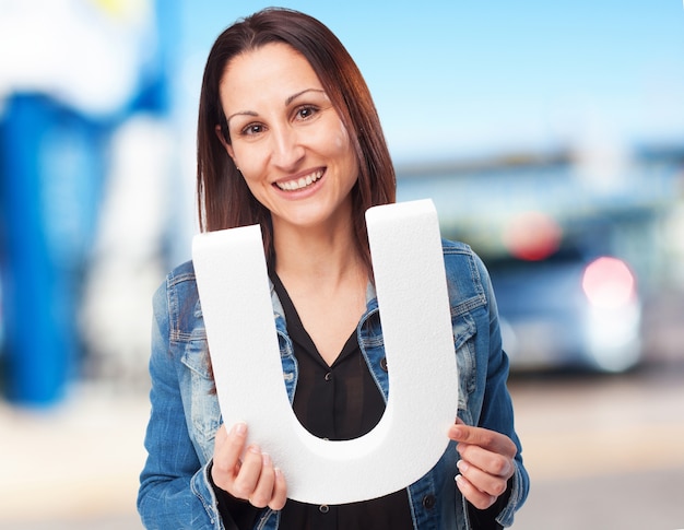 woman holding the U letter