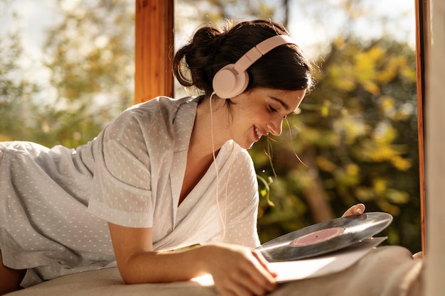 Woman holding vinyl disc medium shot