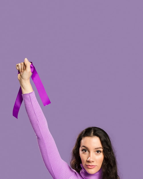 Free Photo woman holding violet ribbon in her hand