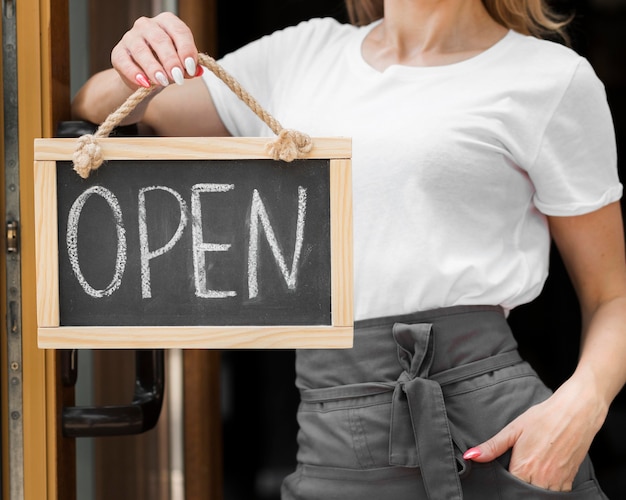 Free Photo woman holding we are open sign