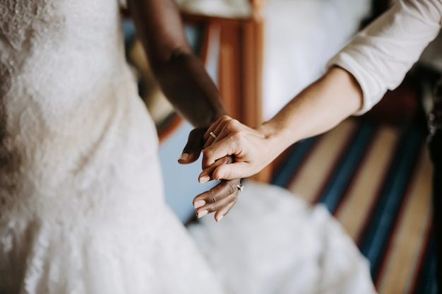 Free Photo woman holds hand of african american bride