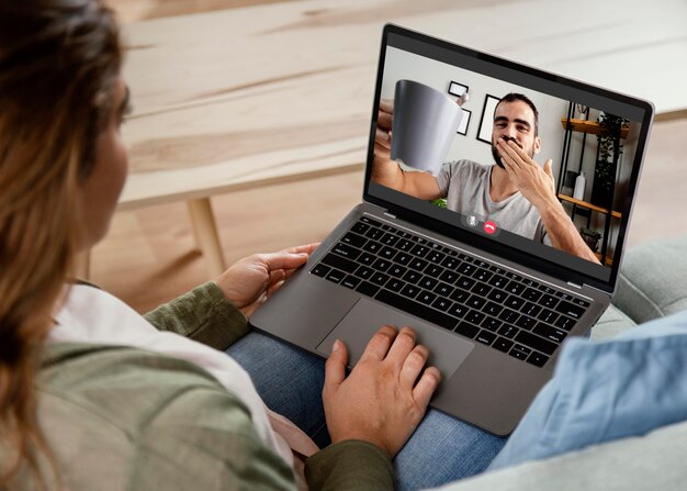 Woman at home having video call on laptop