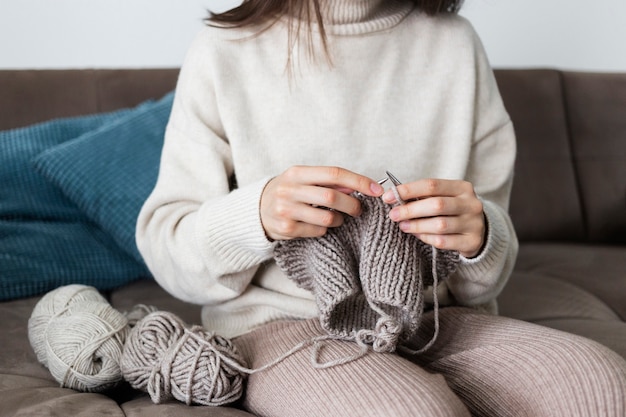 Woman at home knitting close up