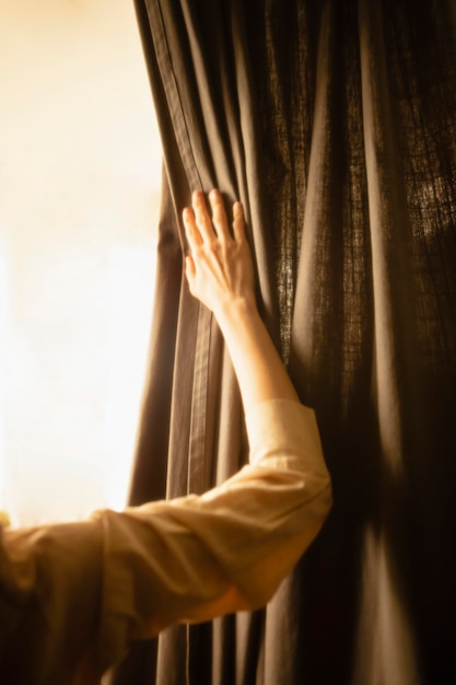 Free Photo woman at home with mysterious day lights around her