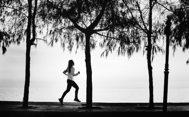 Free Photo a woman jogging on a beach