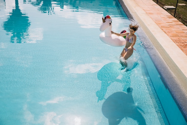 Free photo woman jumping into pool