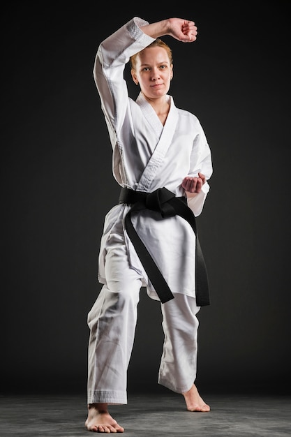 Woman in karate kimono posing