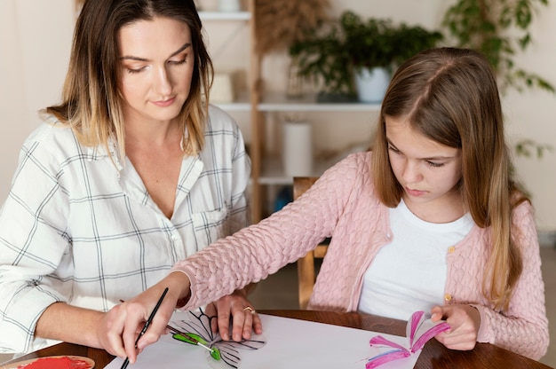 Woman and kid painting together