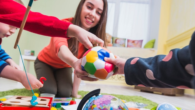 Woman and kids playing on floor