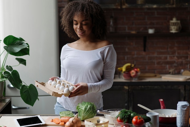 Woman in kitchen with eggs