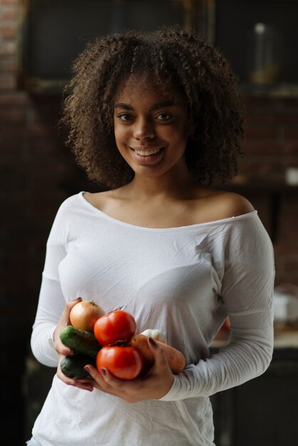 Woman in kitchen with fresh vegetables