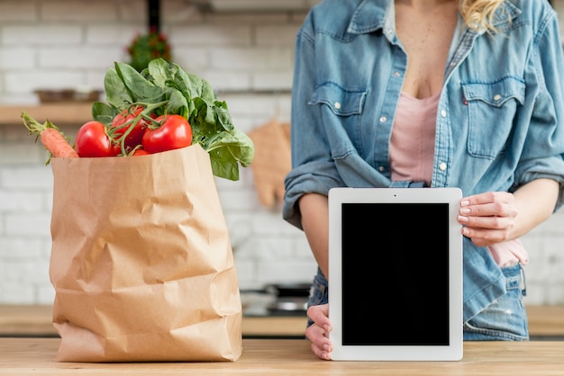 Woman in the kitchen with a tablet