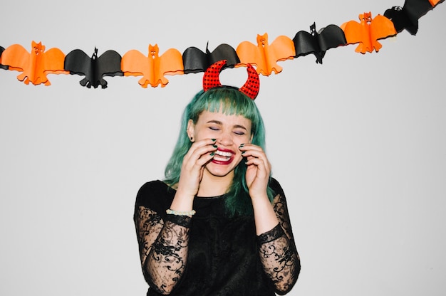 Woman laughing in Halloween decorations