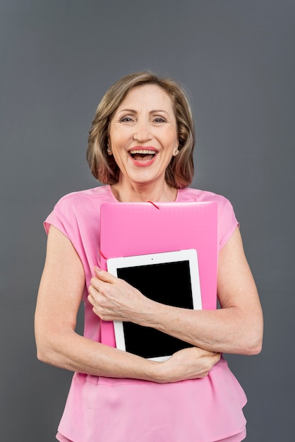 Woman laughing and holding tablet