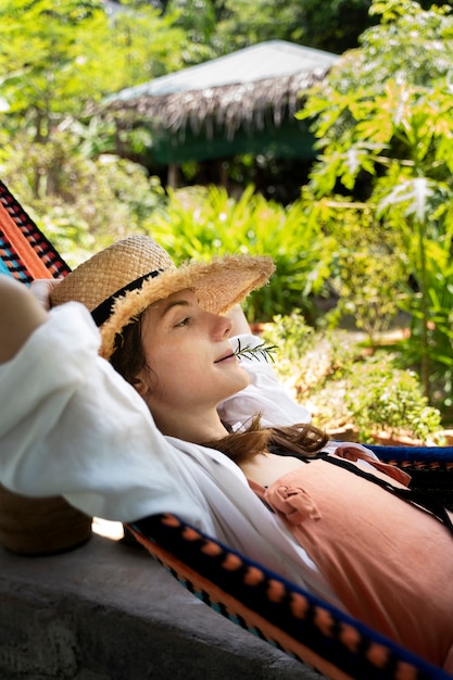 Woman laying in hammock side view