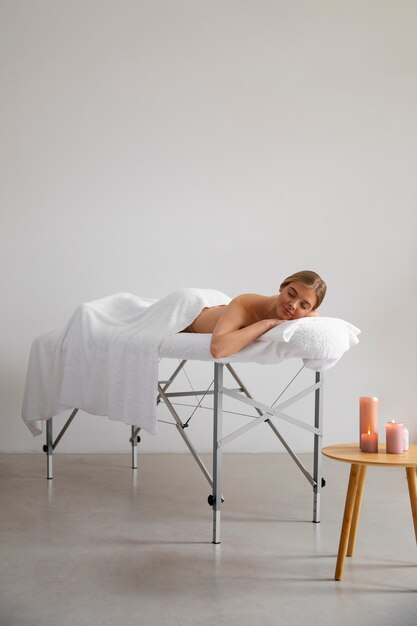 Woman laying on massage bed ready for session