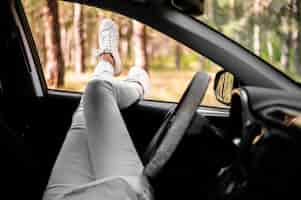 Free photo woman legs out of car window