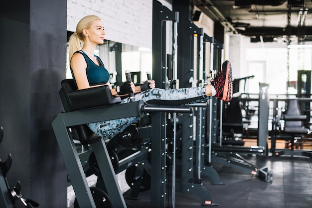 Free Photo woman lifting legs on exercise machine