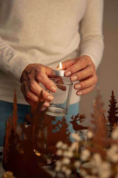 Free photo woman lighting wreath candle on fire